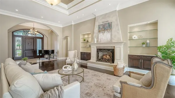 a view of a dining room with furniture a chandelier and wooden floor