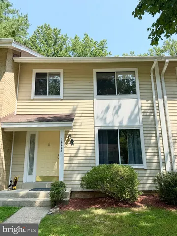 a view of a livingroom with wooden floor and stairs