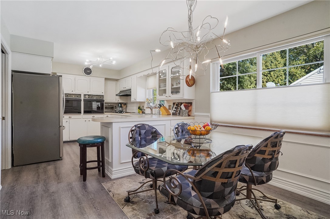 2441 Stockbridge Road Akron, OH 44313 - Photo 21 of 43 Dining area featuring a notable chandelier and dark hardwood / wood-style flooring