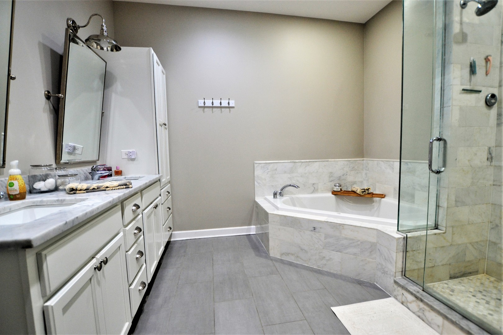 2900 West Irving Park Road, Unit 404 Chicago, IL 60618 - Photo 17 of 26 a bathroom with a double vanity sink a mirror and a bathtub