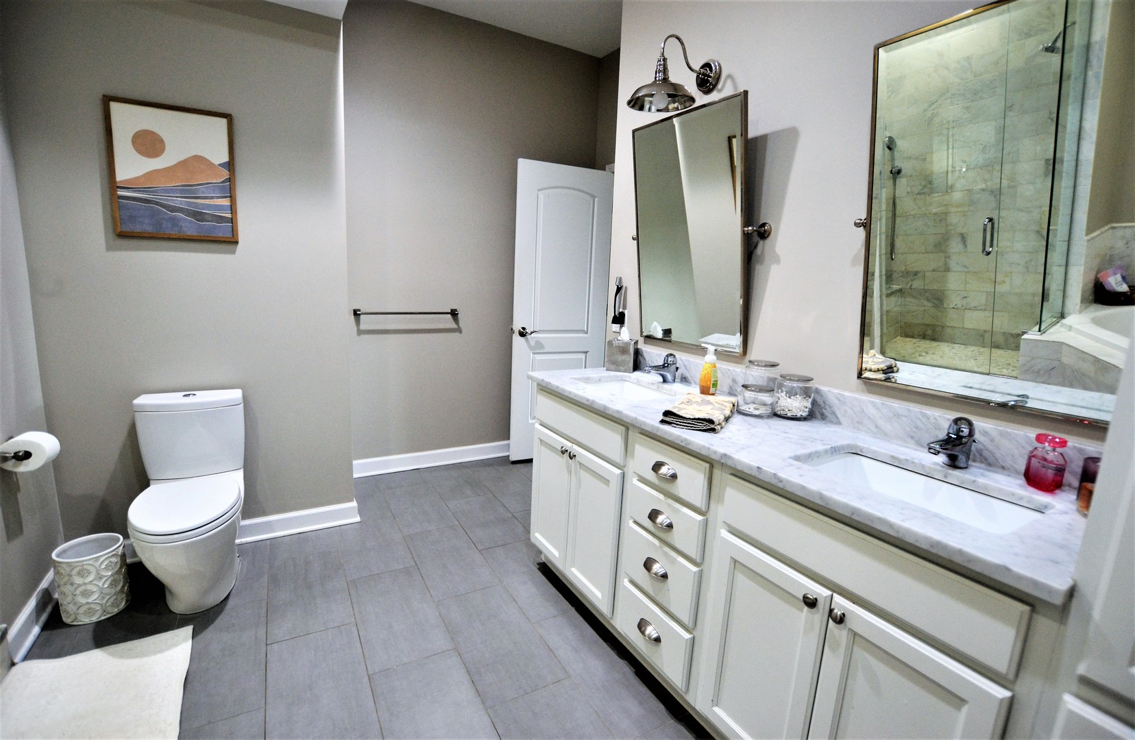 2900 West Irving Park Road, Unit 404 Chicago, IL 60618 - Photo 18 of 26 a bathroom with a double vanity sink toilet and shower