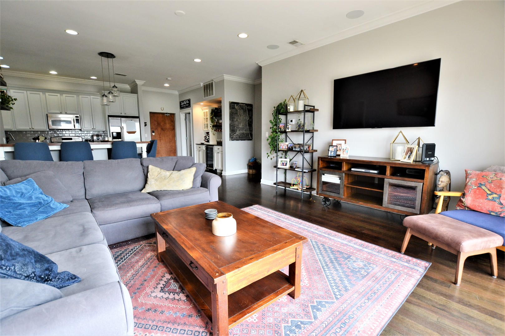 2900 West Irving Park Road, Unit 404 Chicago, IL 60618 - Photo 6 of 26 a living room with furniture and a flat screen tv