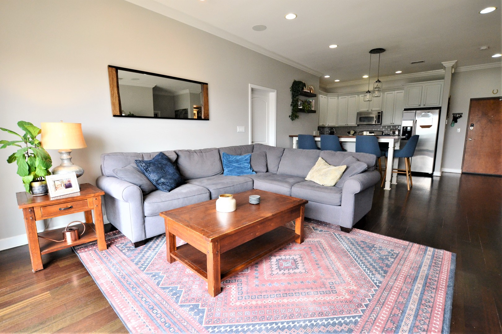 2900 West Irving Park Road, Unit 404 Chicago, IL 60618 - Photo 7 of 26 a living room with furniture and a dining table with wooden floor