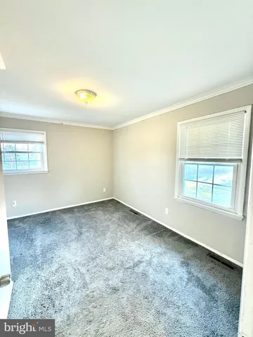 an empty room with a empty space and windows