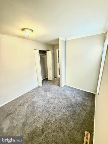 a view of a big room with closet and wooden floor