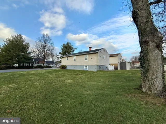 a front view of house with yard and trees