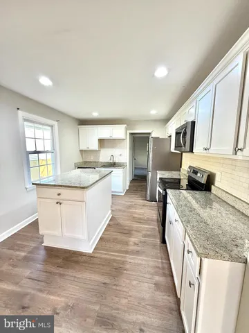 a large kitchen with a stove top oven