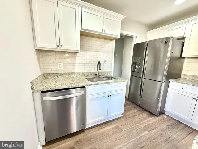 a kitchen with stainless steel appliances granite countertop a refrigerator sink and cabinets