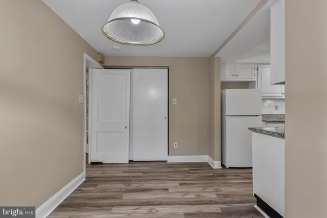 a view of a room with wooden floor and bathroom