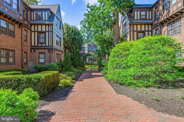 a view of a brick building next to a yard