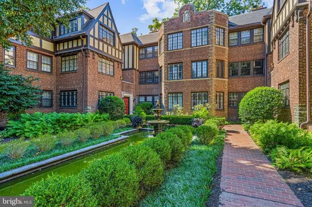 a view of a brick building next to a yard