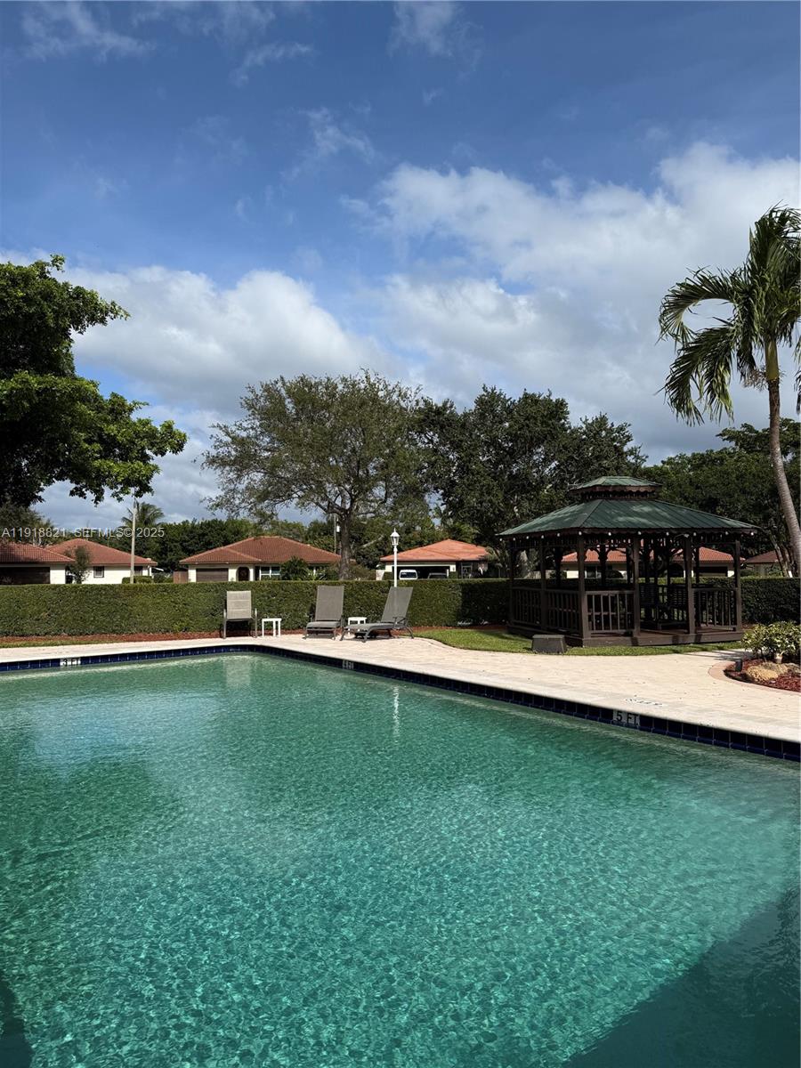 300 Northwest 42nd Street Boca Raton, FL 33431 - Photo 2 of 32 a view of a swimming pool with a yard