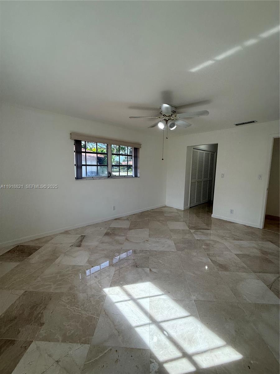 300 Northwest 42nd Street Boca Raton, FL 33431 - Photo 25 of 32 a view of a big room with windows and chandelier fan