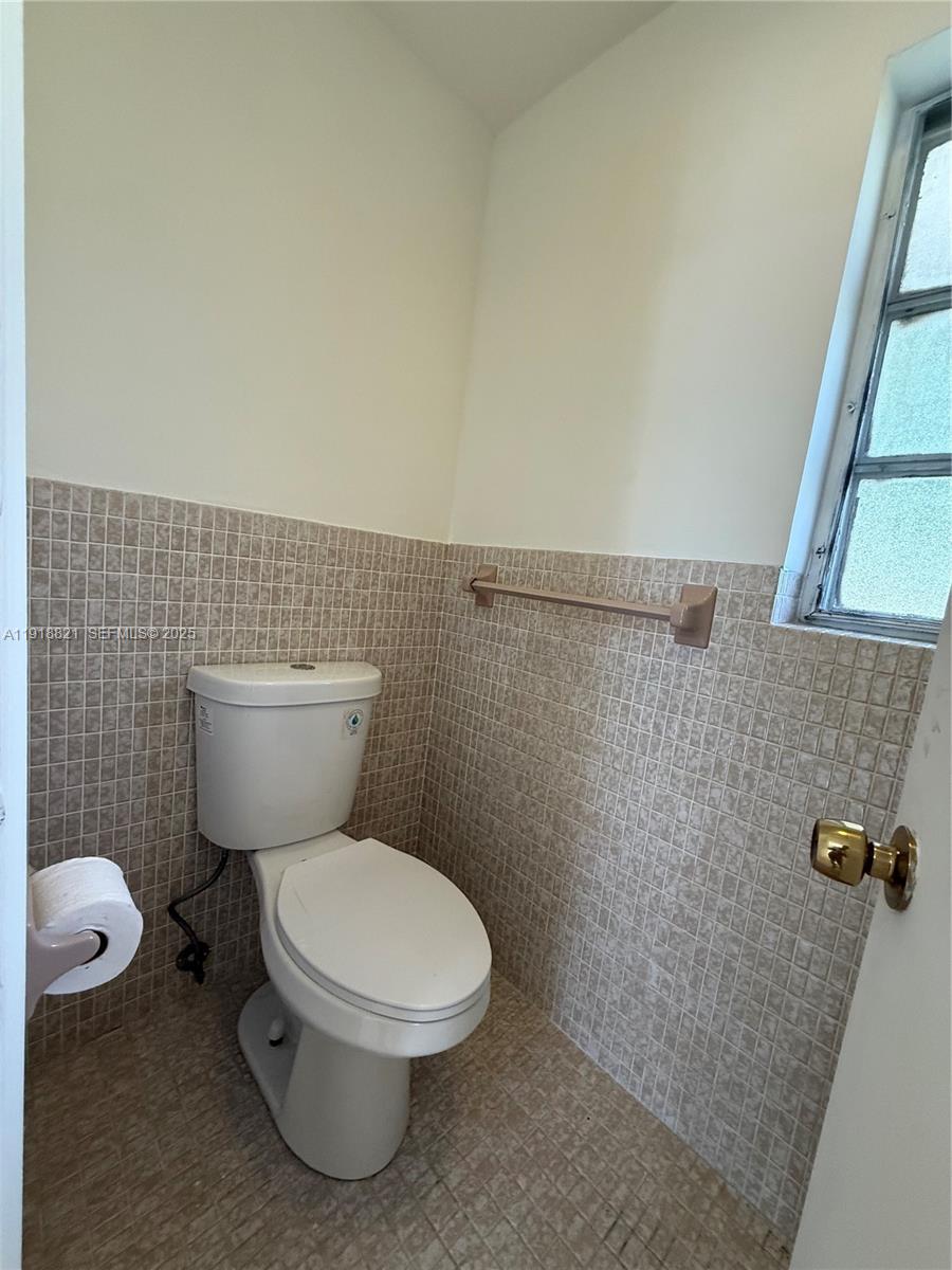 300 Northwest 42nd Street Boca Raton, FL 33431 - Photo 28 of 32 a white toilet sitting next to a bathroom sink