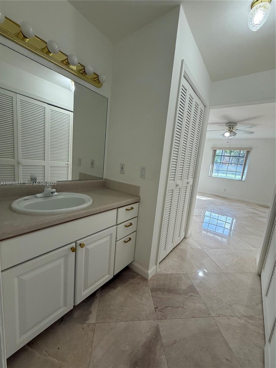 300 Northwest 42nd Street Boca Raton, FL 33431 - Photo 30 of 32 a bathroom with a sink a vanity and a mirror