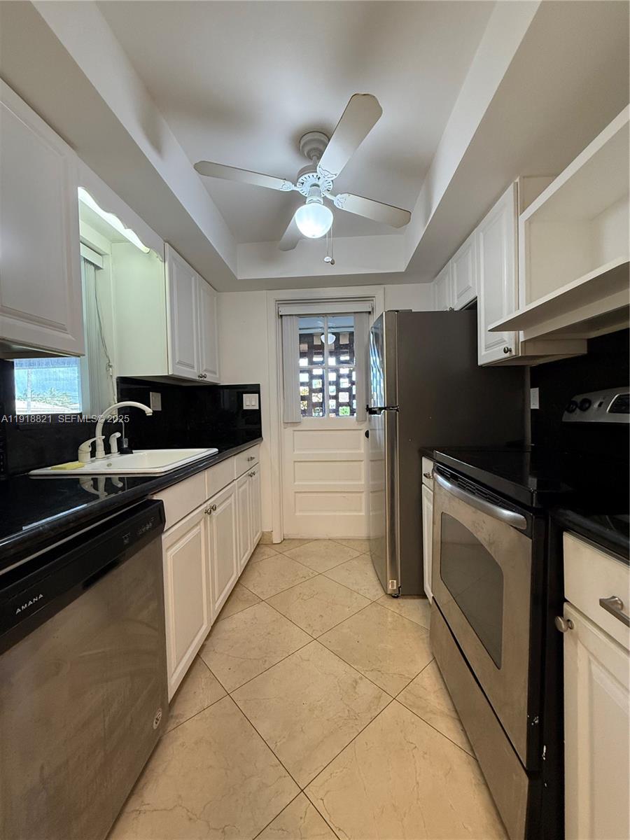 300 Northwest 42nd Street Boca Raton, FL 33431 - Photo 10 of 32 a kitchen with a sink cabinets and stainless steel appliances