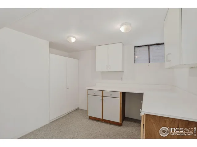 a kitchen with cabinets and window
