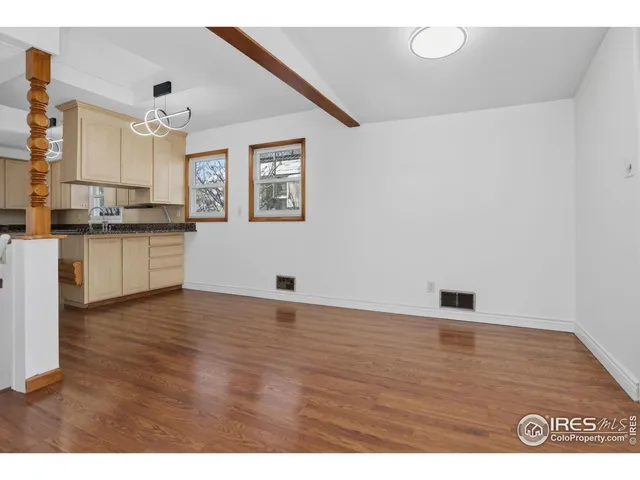 a view of kitchen with granite countertop cabinets and wooden floor