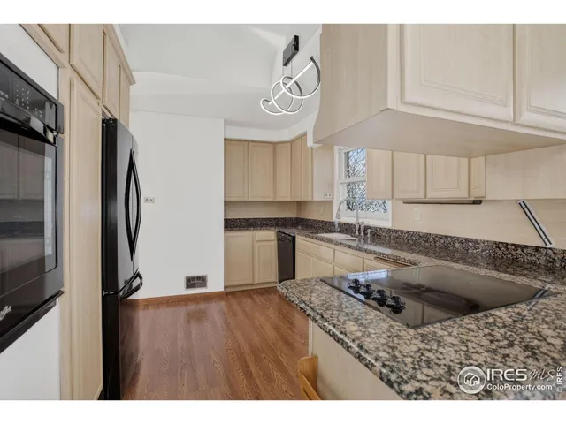 a kitchen with a refrigerator a stove a sink and a cabinets