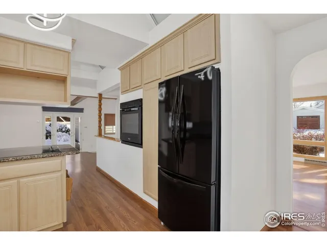 a kitchen with a refrigerator and a stove top oven