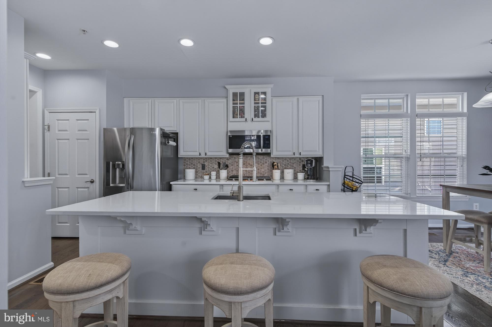 1317 Yourtee Spring Drive Brunswick, MD 21716 - Photo 12 of 73 a kitchen with stainless steel appliances granite countertop a sink and a refrigerator