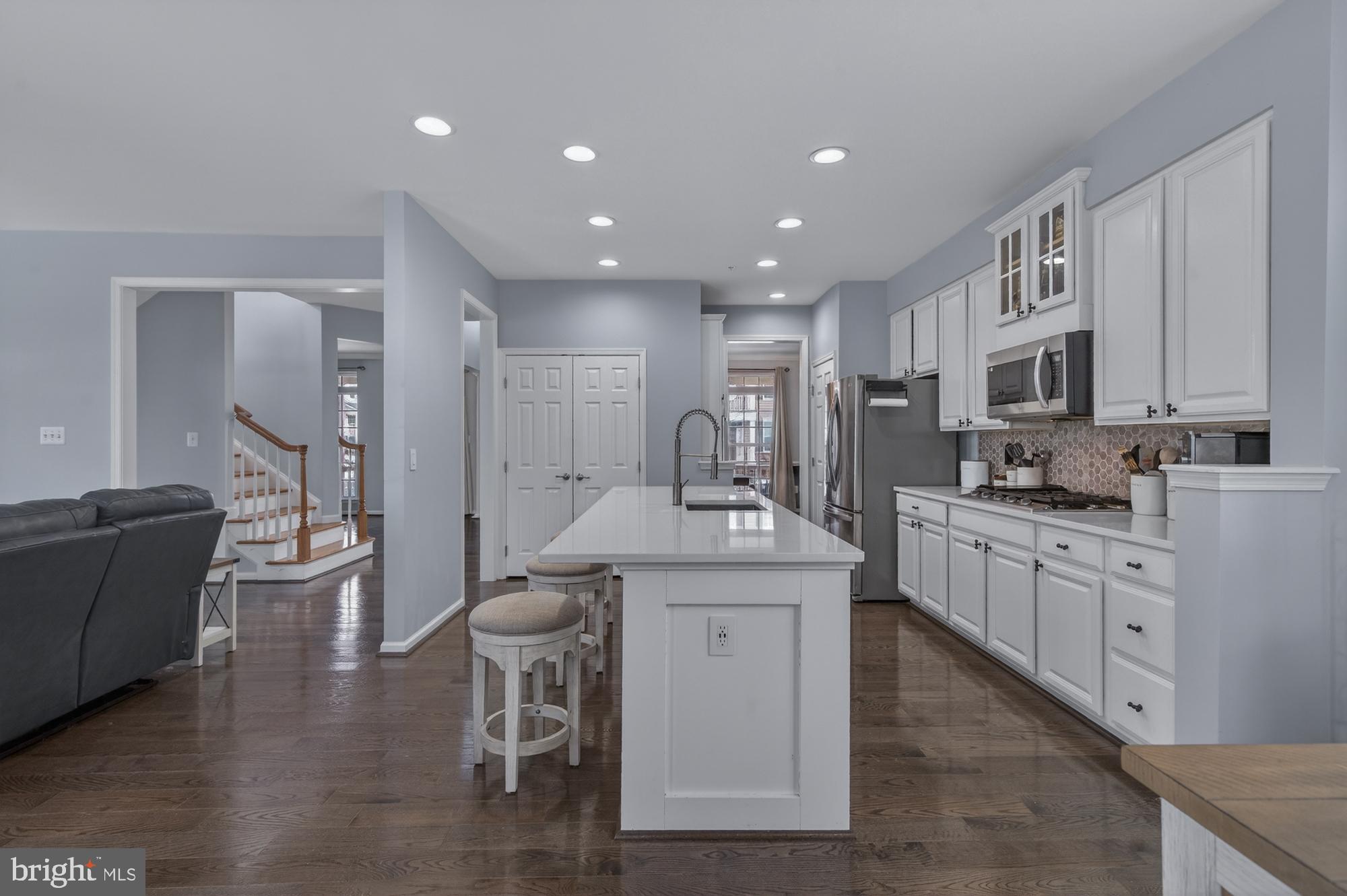 1317 Yourtee Spring Drive Brunswick, MD 21716 - Photo 13 of 73 a kitchen with stainless steel appliances kitchen island granite countertop a sink and cabinets