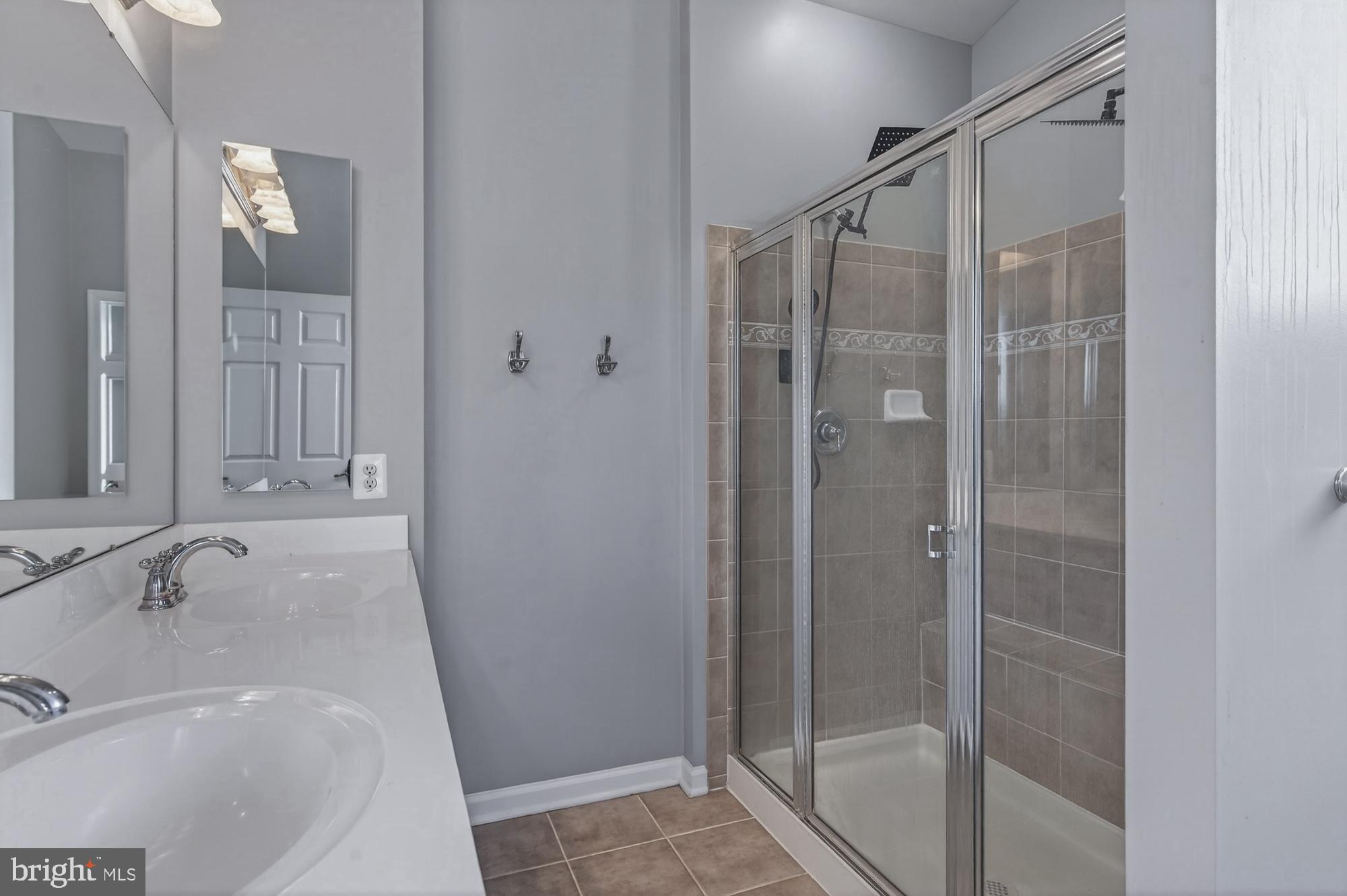 1317 Yourtee Spring Drive Brunswick, MD 21716 - Photo 33 of 73 a bathroom with a shower and a sink