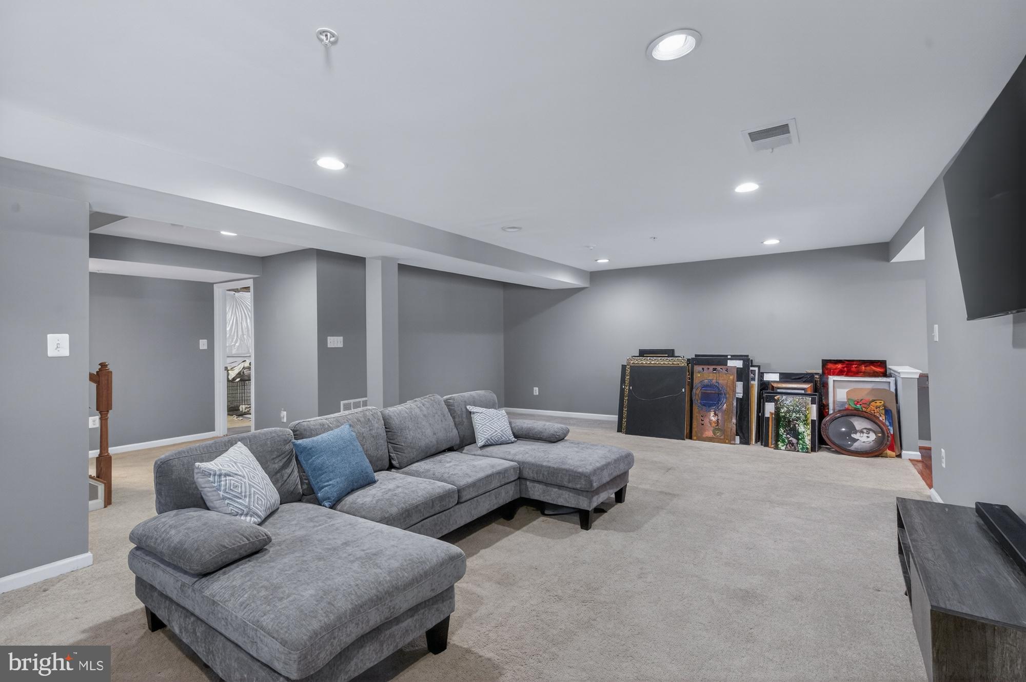 1317 Yourtee Spring Drive Brunswick, MD 21716 - Photo 41 of 73 a living room with furniture and a flat screen tv