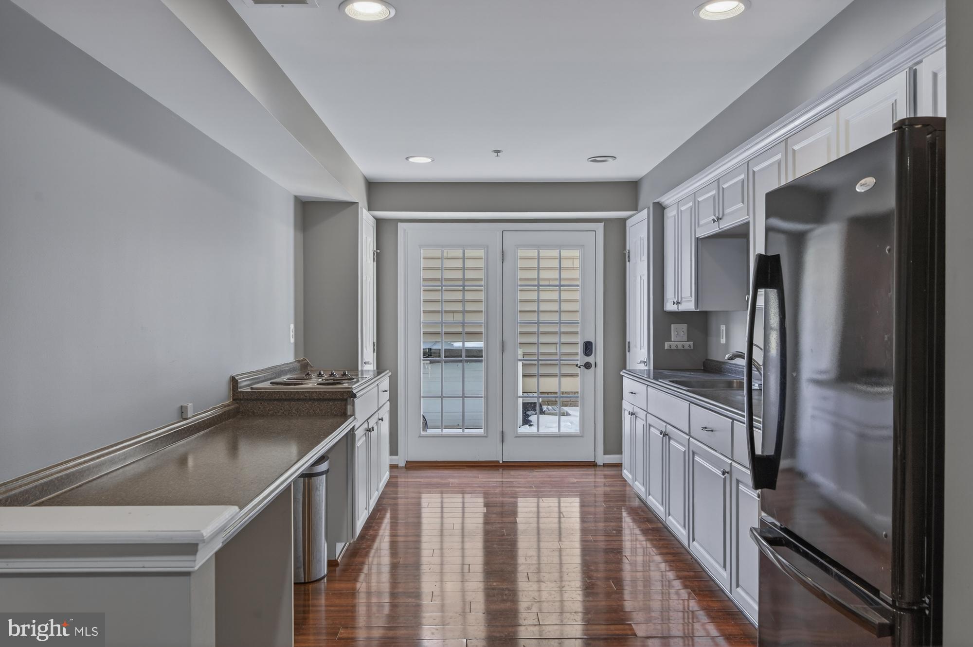 1317 Yourtee Spring Drive Brunswick, MD 21716 - Photo 44 of 73 a kitchen with granite countertop a refrigerator stove and sink