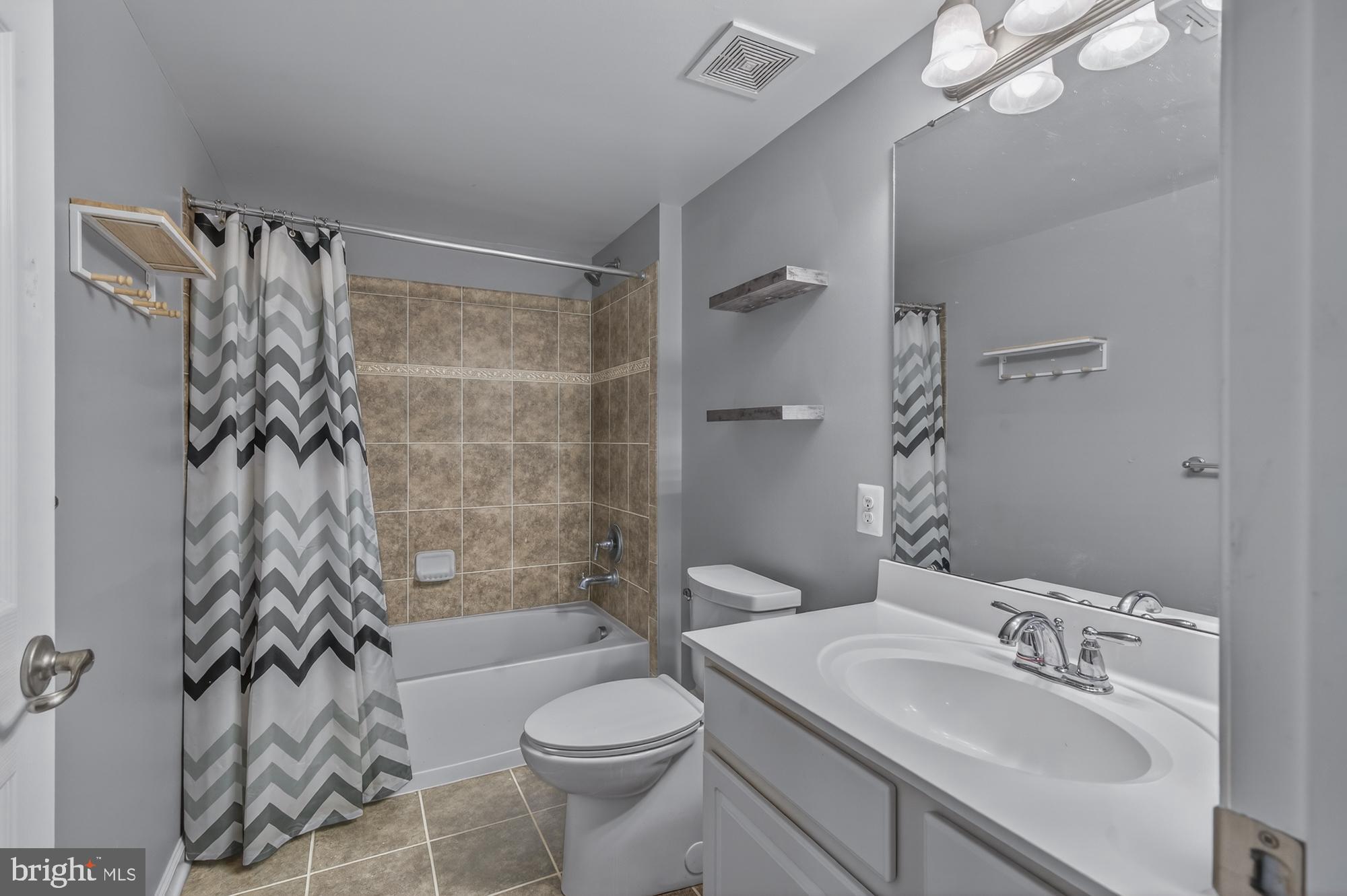 1317 Yourtee Spring Drive Brunswick, MD 21716 - Photo 46 of 73 a bathroom with a sink toilet and shower