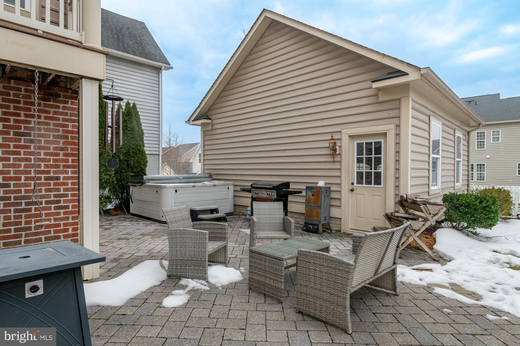 1317 Yourtee Spring Drive Brunswick, MD 21716 - Photo 51 of 73 a view of a patio with couches table and chairs with wooden floor and fence