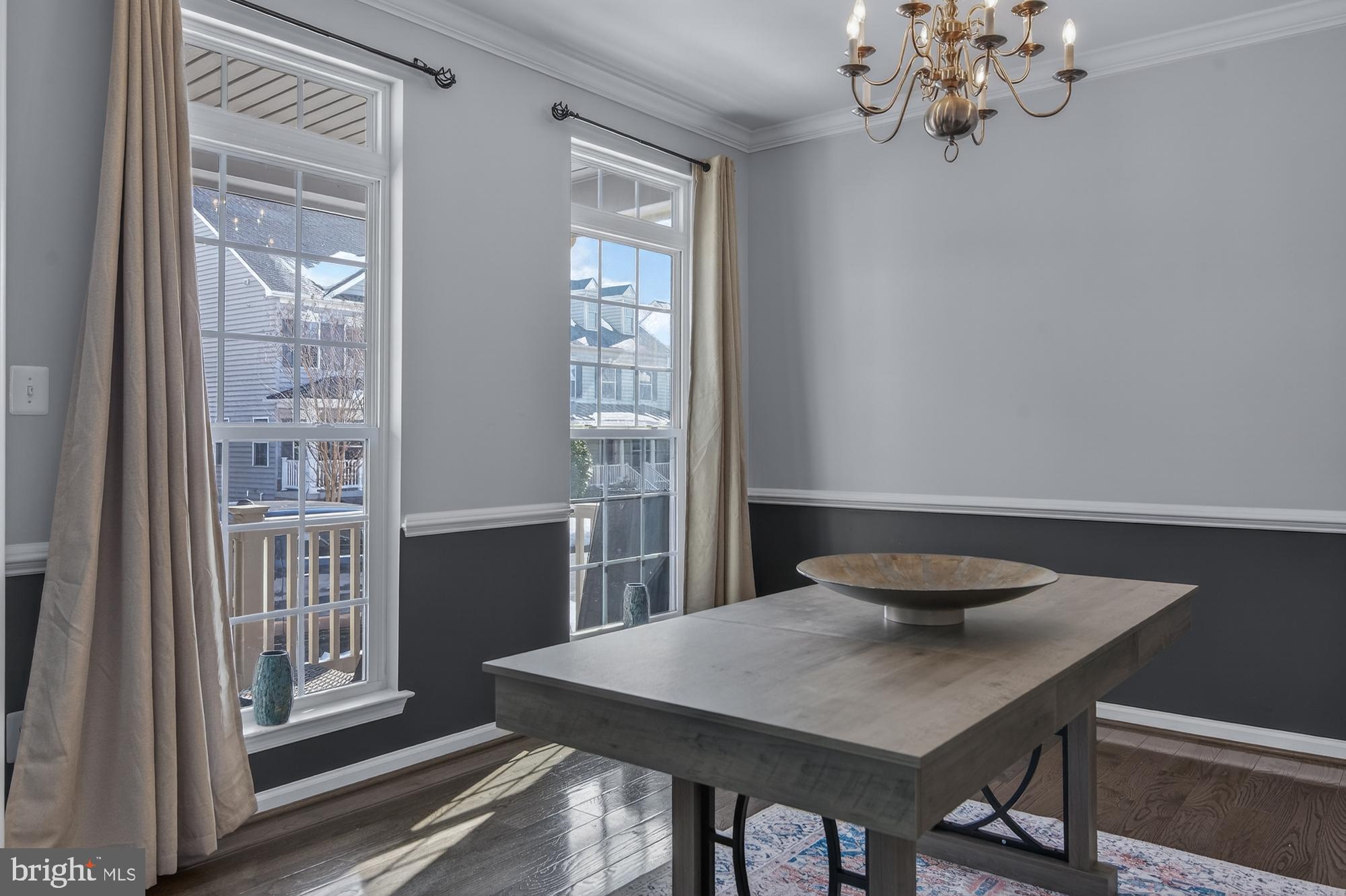 1317 Yourtee Spring Drive Brunswick, MD 21716 - Photo 9 of 73 a view of a dining room with furniture wooden floor and chandelier