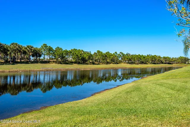 a view of a lake with houses in the back