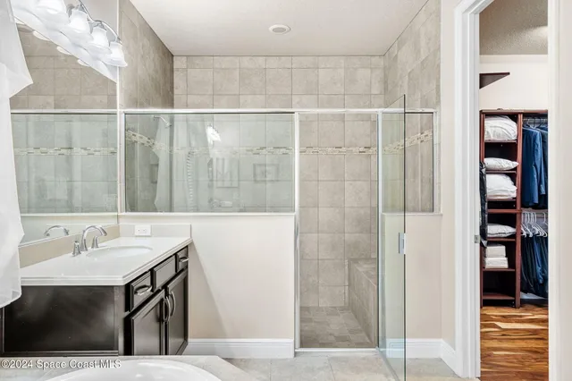 a bedroom with a bed and a ceiling fan