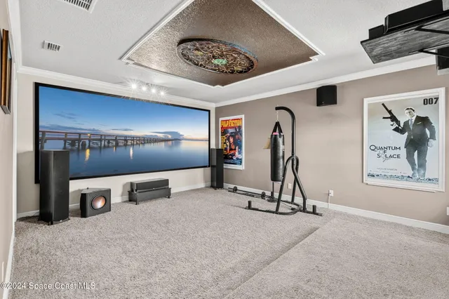 an aerial view of a house with a garden and lake view