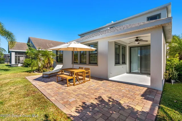 an aerial view of a house with a swimming pool yard and outdoor seating