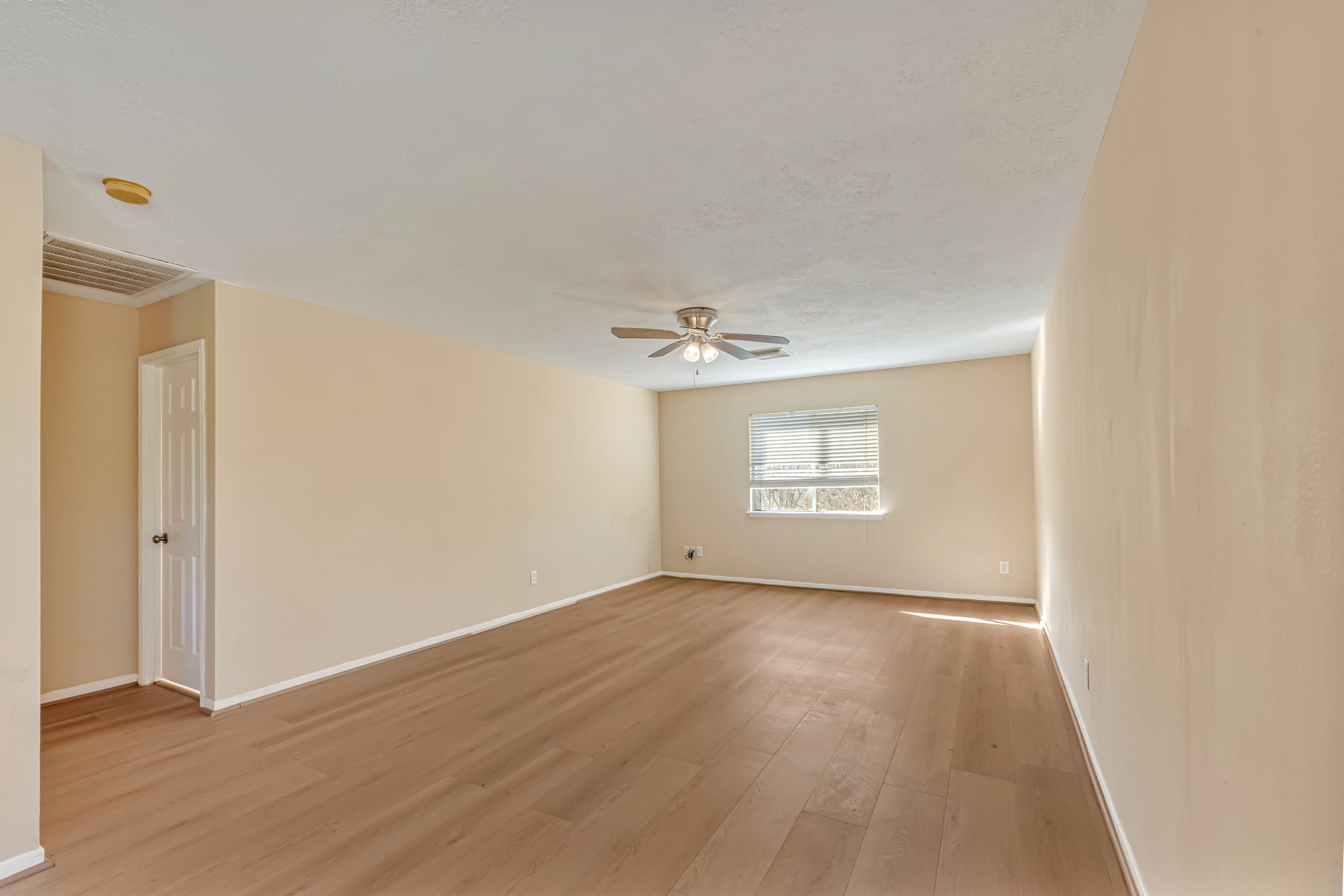914 Chapwood Court Spring, TX 77373 - Photo 12 of 22 an empty room with wooden floor and windows