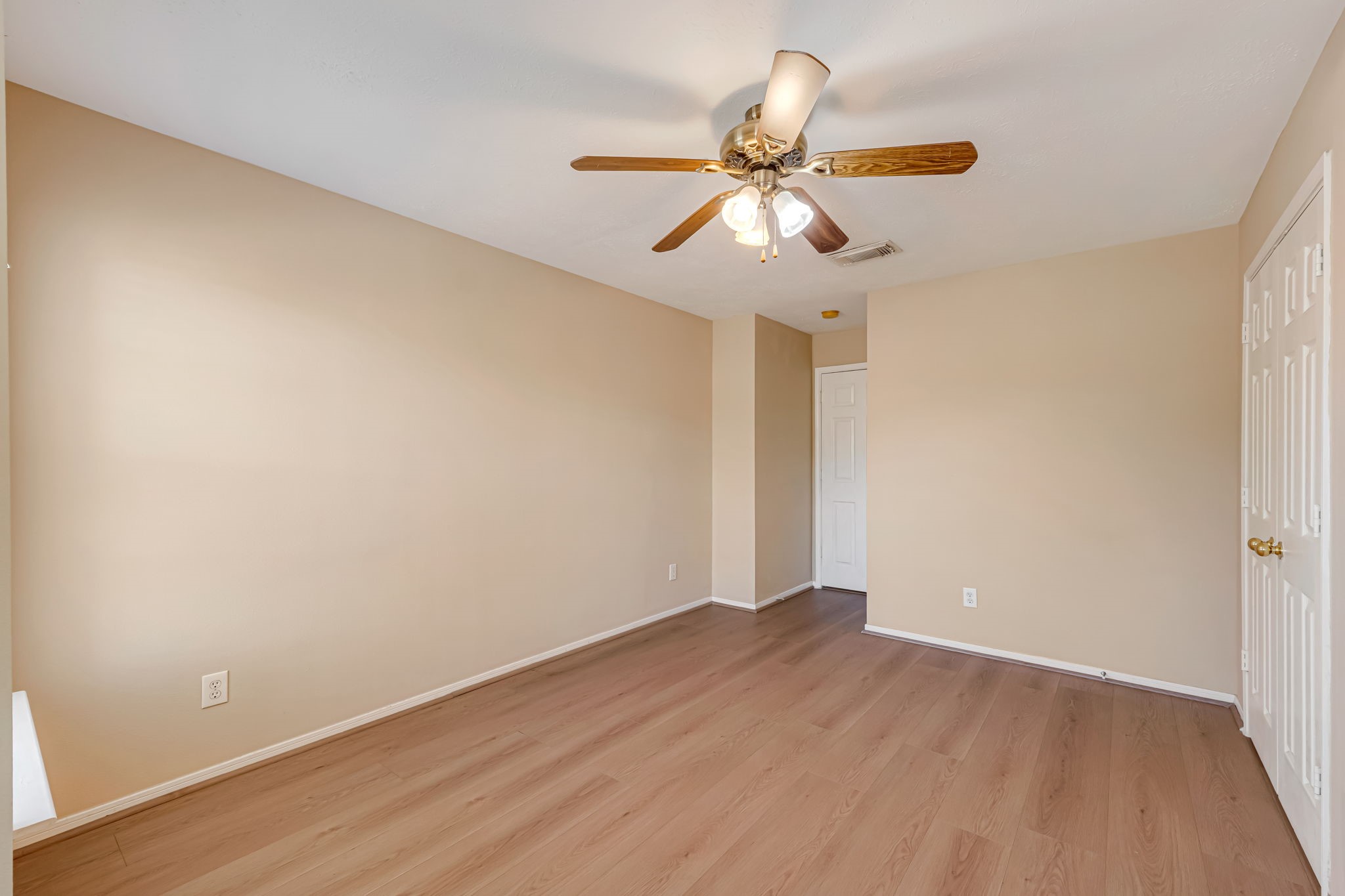 914 Chapwood Court Spring, TX 77373 - Photo 20 of 22 an empty room with wooden floor fan and windows