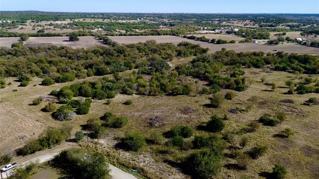 an aerial view of a houses with a yard