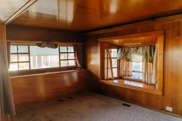 a view of a room with wooden walls