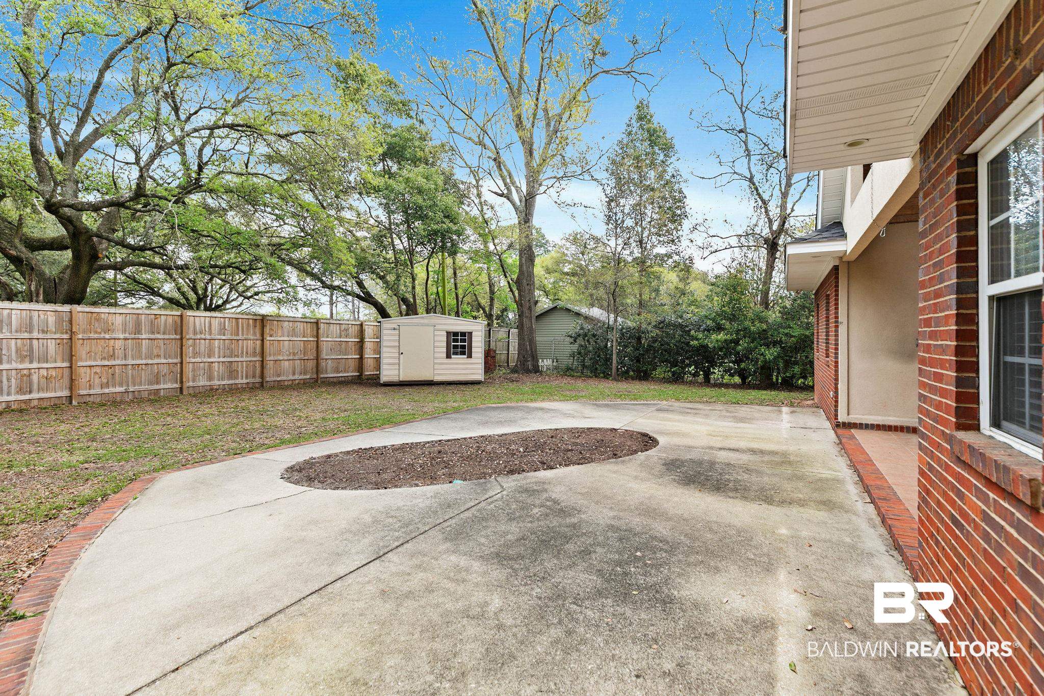 3668 Claridge Road North Mobile, AL 36608 - Photo 93 of 100 Fenced backyard with a storage shed and a patio