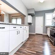 4012 Boarman Avenue Baltimore, MD 21215 - Photo 12 of 43 a kitchen with stainless steel appliances a stove top oven and a refrigerator