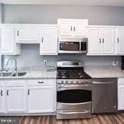 a bathroom with a sink a vanity and a mirror