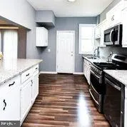a view of a room with wooden floor