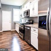 4012 Boarman Avenue Baltimore, MD 21215 - Photo 16 of 43 a kitchen with stainless steel appliances granite countertop a stove a sink and a microwave