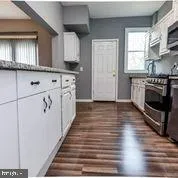 an empty room with wooden floor and a window