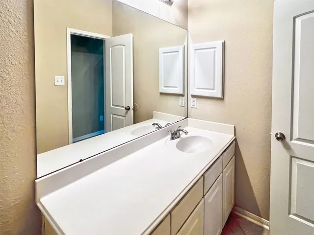 a view of a swimming pool with a yard and palm trees