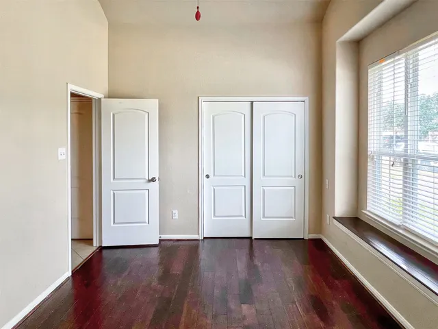 a view of a room with wooden floor and white doors