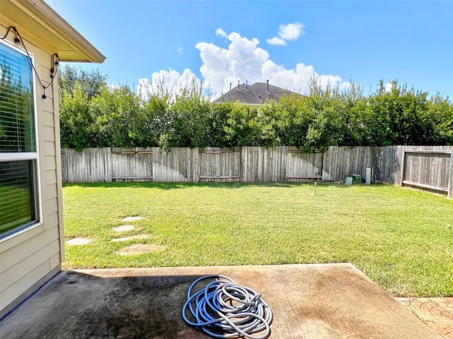 a view of a backyard with a swimming pool