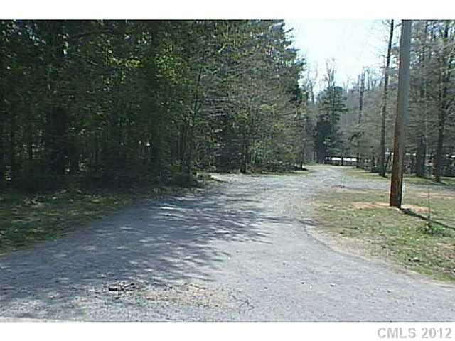 10153 Robert Bost Road Midland, NC 28107 - Photo 2 of 2 a view of a dirt road with trees in the background